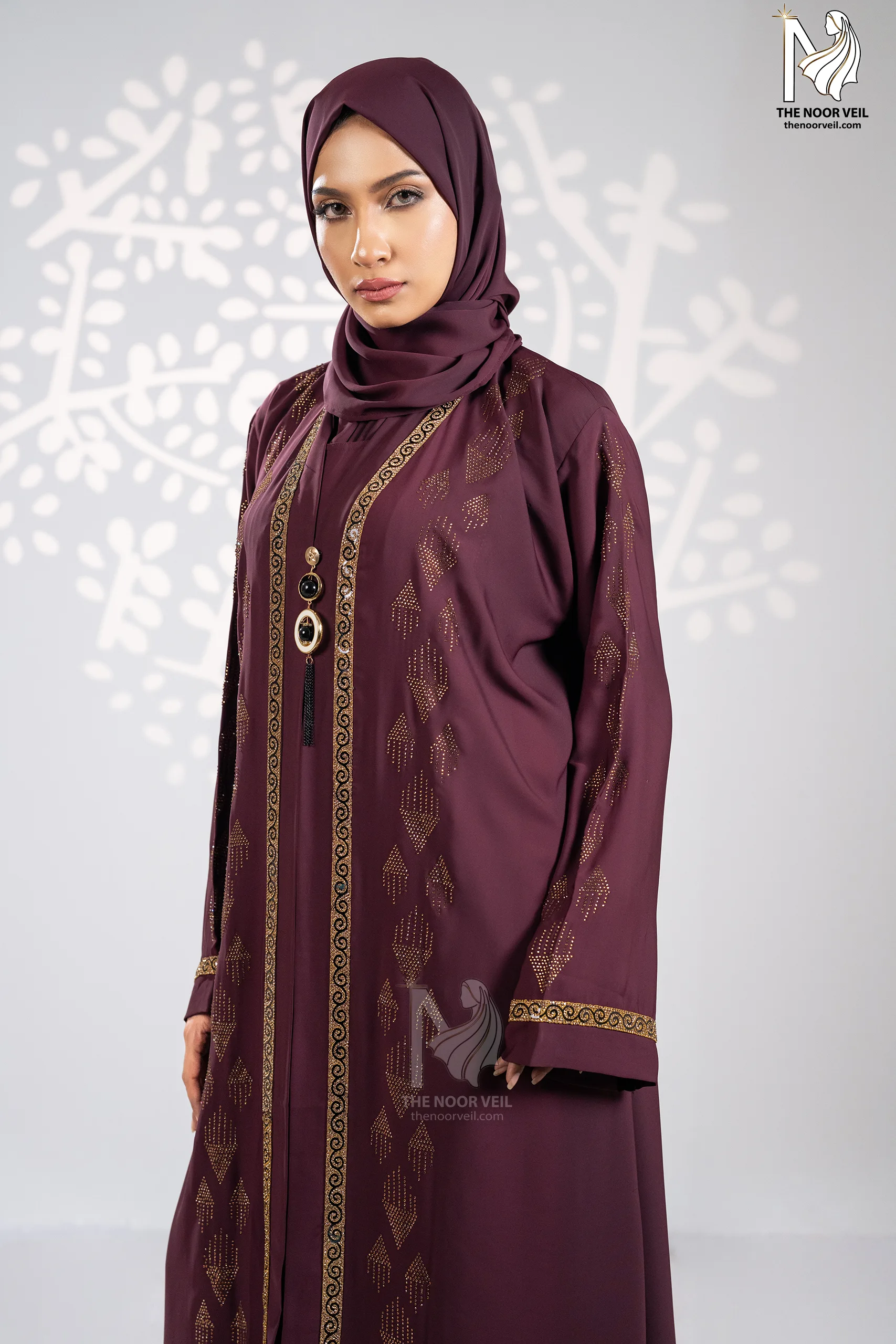 Side portrait view of the Kyra Abaya Deep Maroon